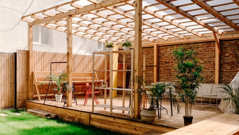 brown wooden fence near green plants during daytime